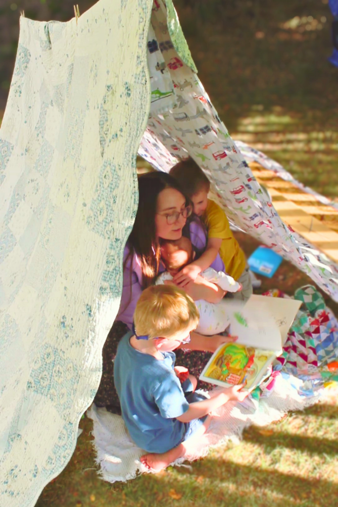 mama in a backyard tent with the kids